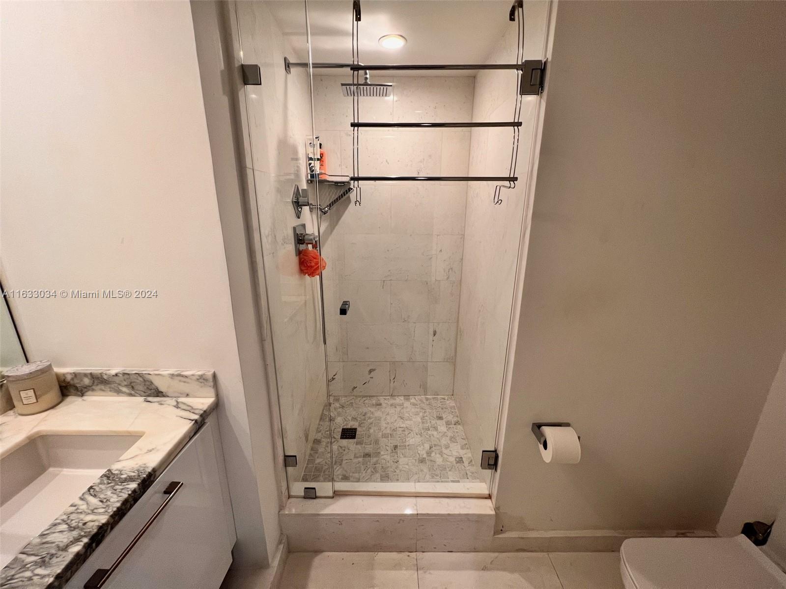 848 Brickell Key Drive, Unit 3701 Miami, FL 33131 - Photo 64 of 84 a bathroom with a granite countertop sink toilet and shower
