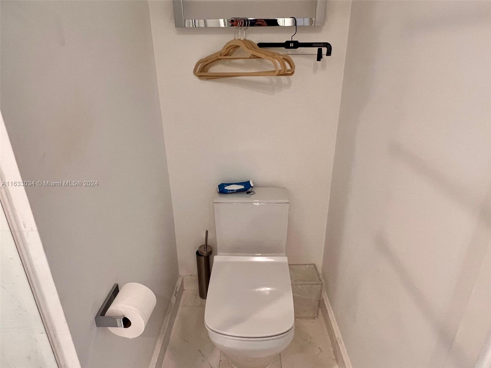 848 Brickell Key Drive, Unit 3701 Miami, FL 33131 - Photo 66 of 84 a white toilet sitting next to a white sink