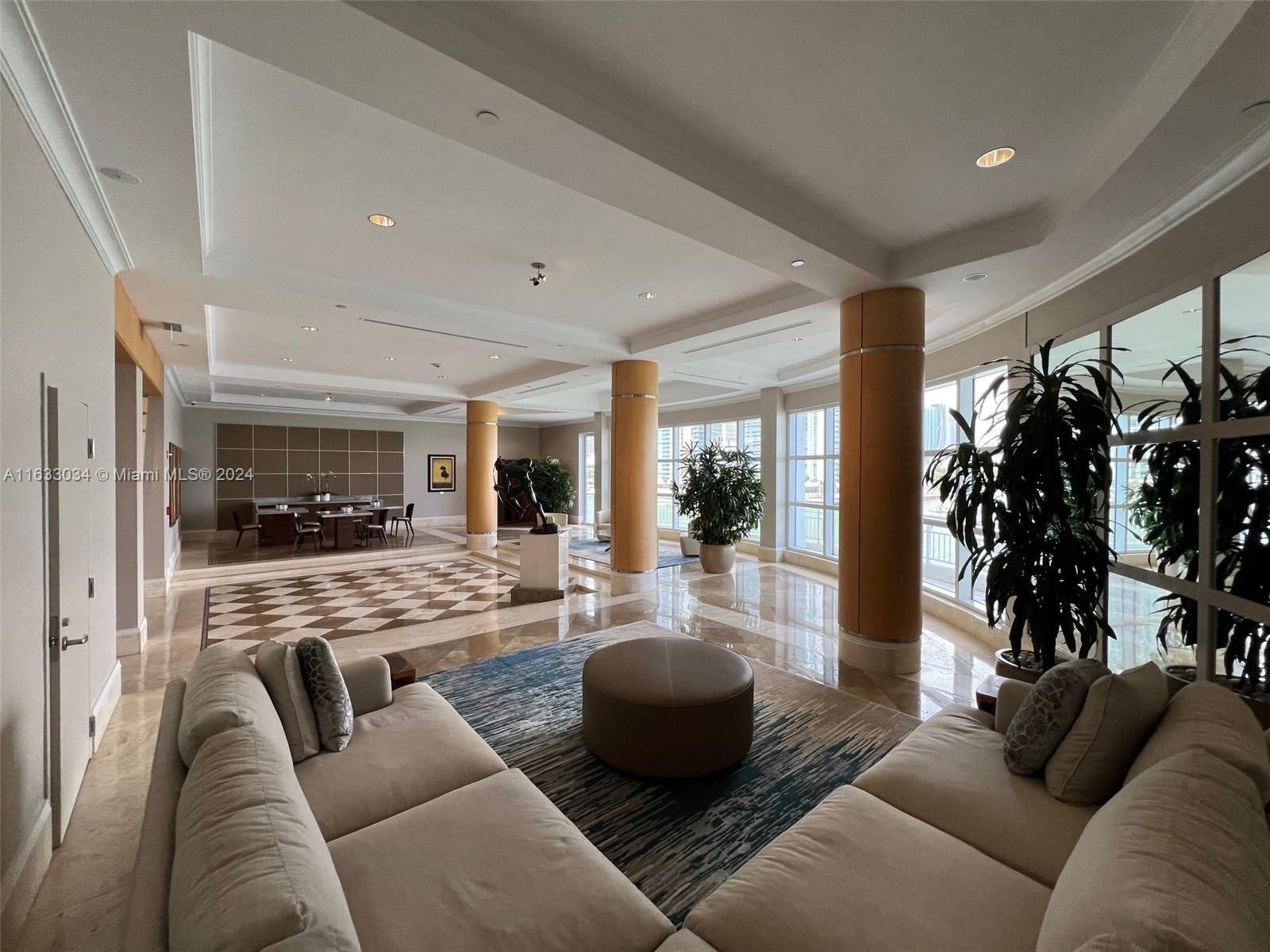 848 Brickell Key Drive, Unit 3701 Miami, FL 33131 - Photo 72 of 84 a living room with furniture and a large window