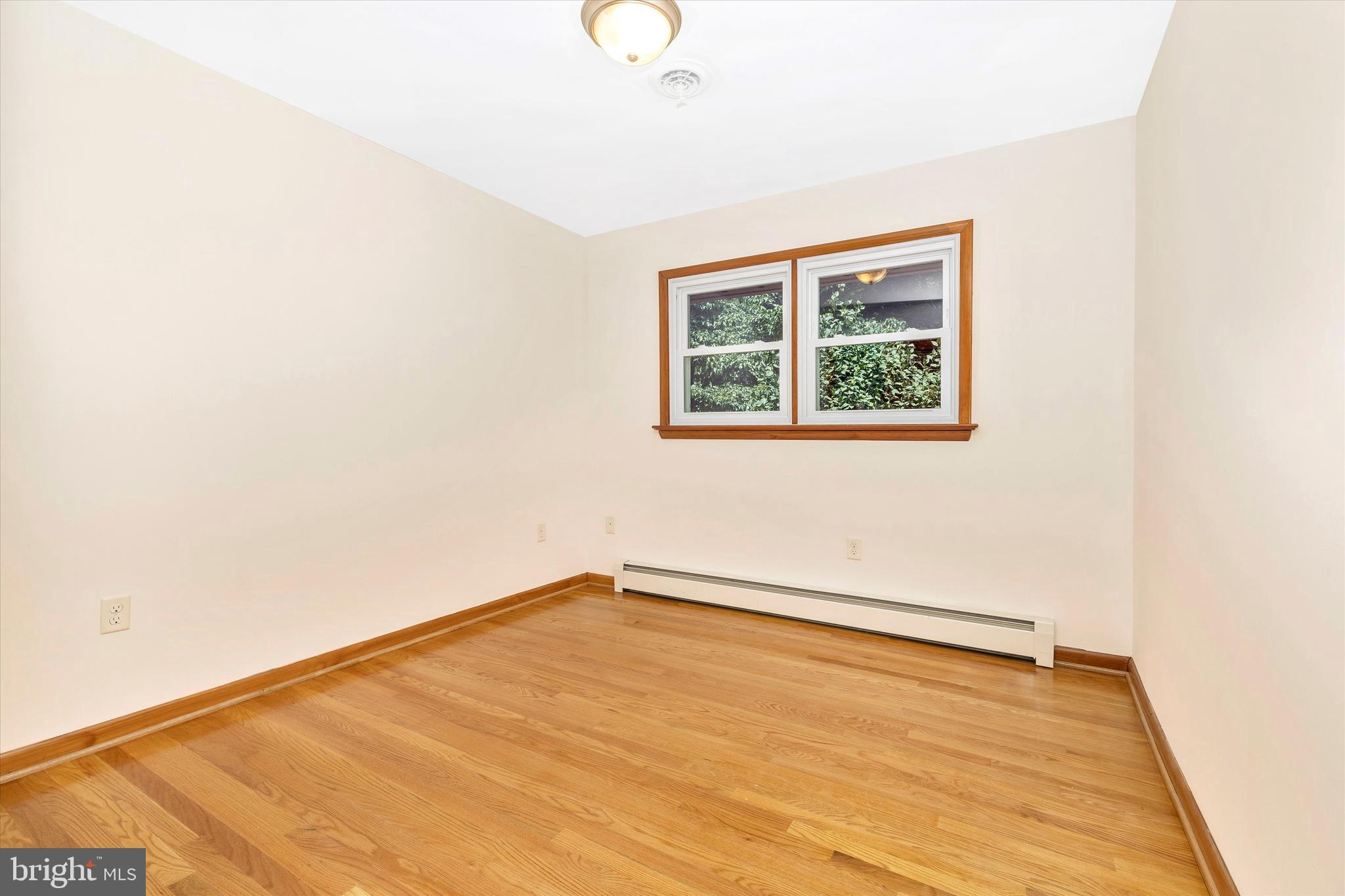 8911 Yellow Springs Road Frederick, MD 21702 - Photo 24 of 37 a view of an empty room with wooden floor and a window