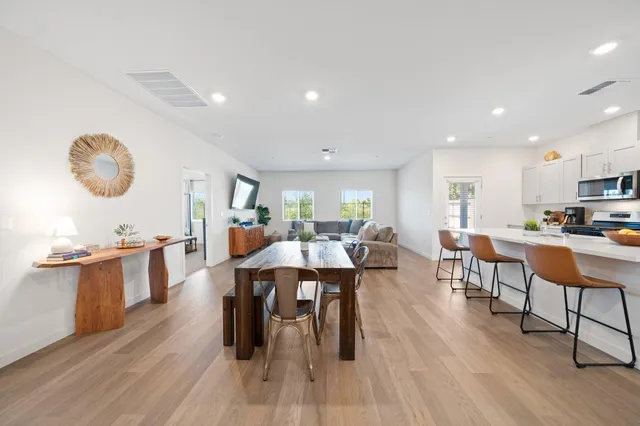 a large kitchen with a table and chairs