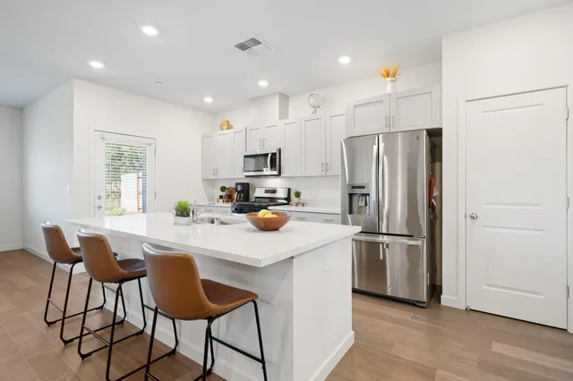 a kitchen with stainless steel appliances a refrigerator stove microwave and cabinets