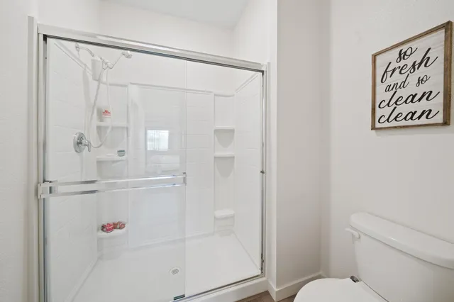 a bathroom with a shower and a toilet