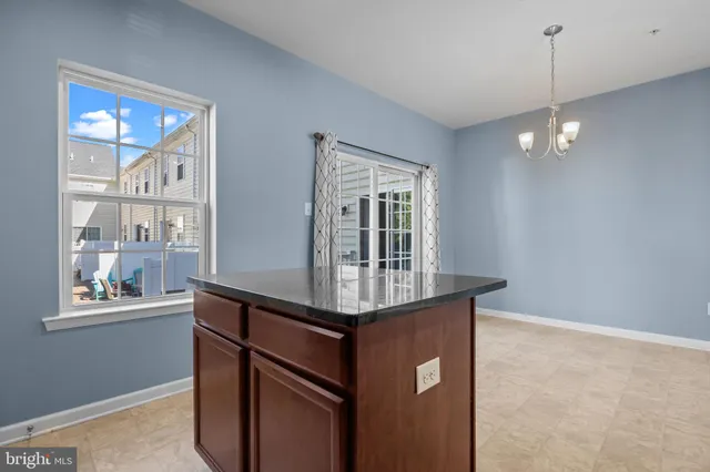 a kitchen with stainless steel appliances granite countertop a stove a sink and a window