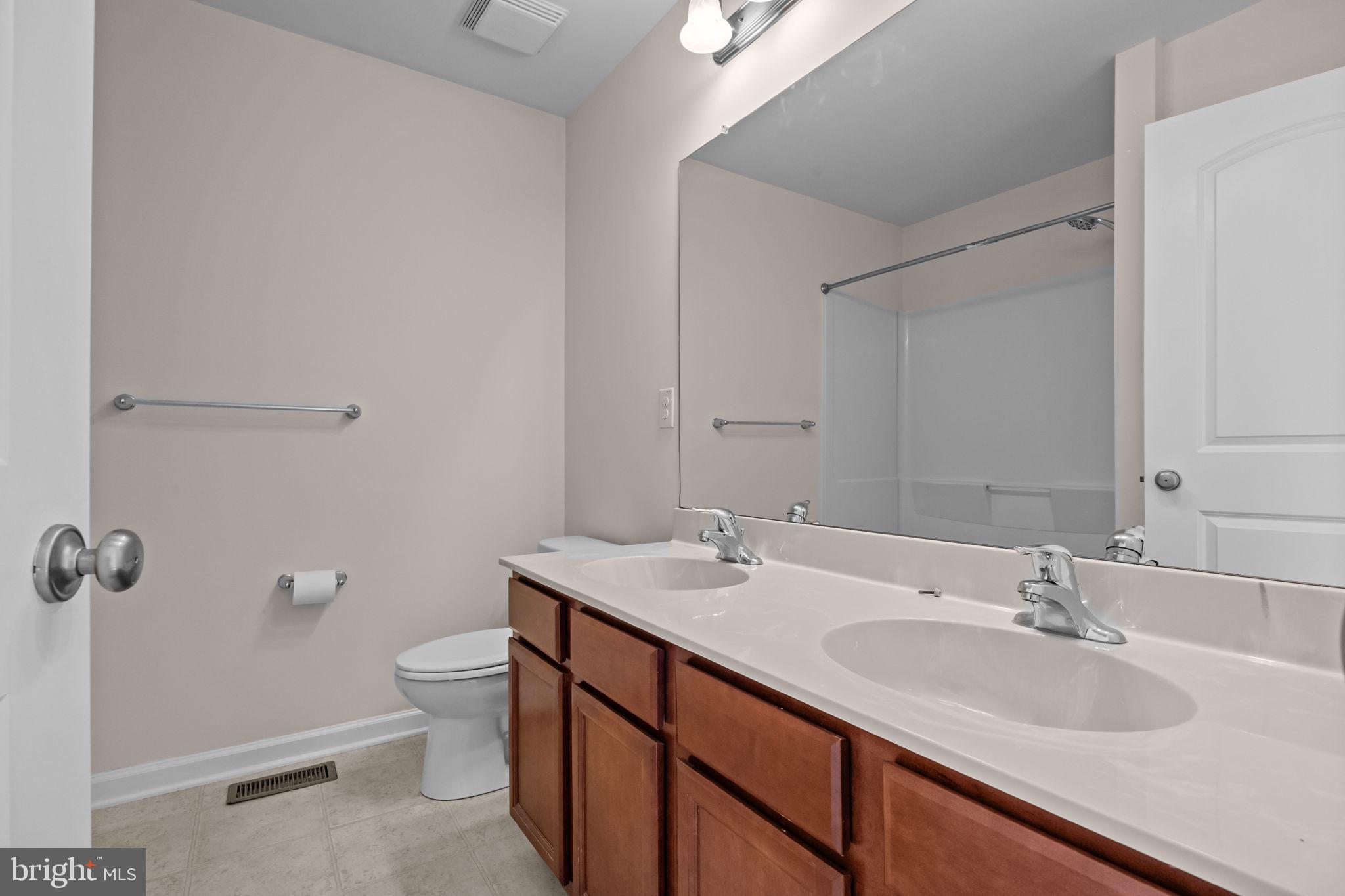 3753 Jacob Stout Road, Unit 3 Doylestown, PA 18902 - Photo 20 of 34 a bathroom with a double vanity sink and mirror with toilet