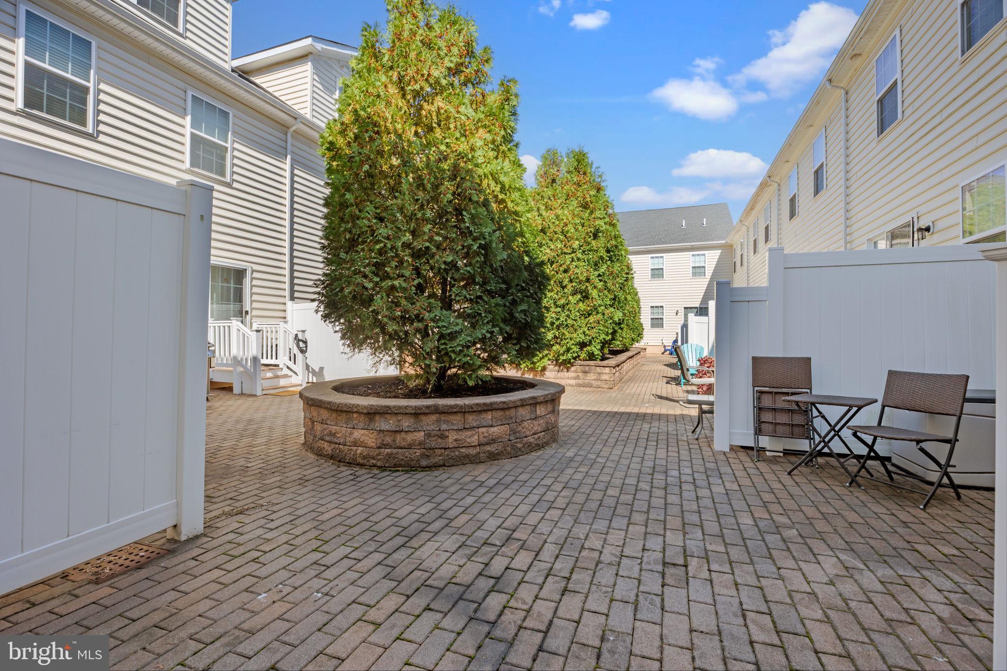 3753 Jacob Stout Road, Unit 3 Doylestown, PA 18902 - Photo 31 of 34 a view of a patio with table and chairs and potted plants