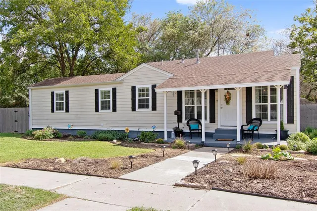 a front view of a house with a yard and outdoor seating