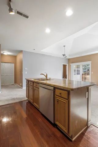 a kitchen with granite countertop a stove and a refrigerator