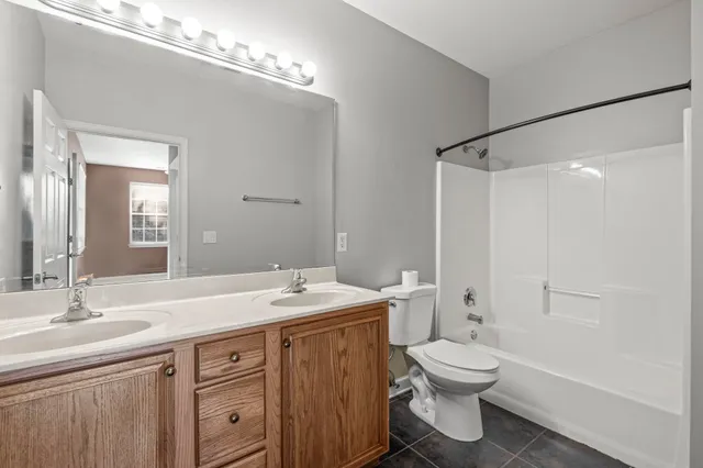 a bathroom with a sink toilet vanity and shower