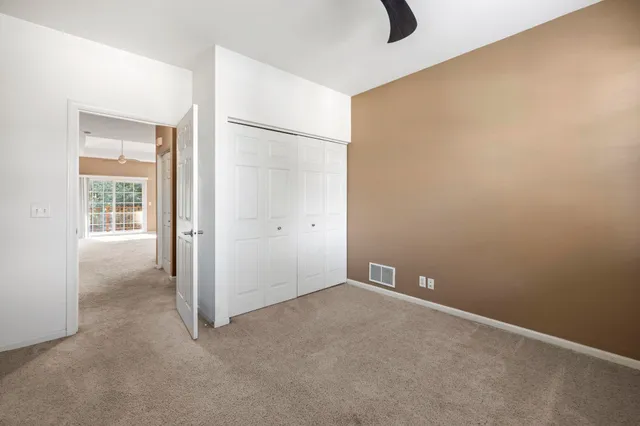 an empty room with windows and closet