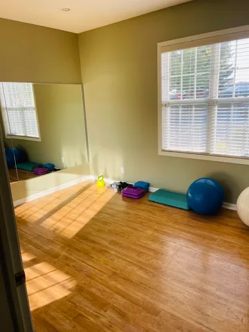 a room with pool table and windows