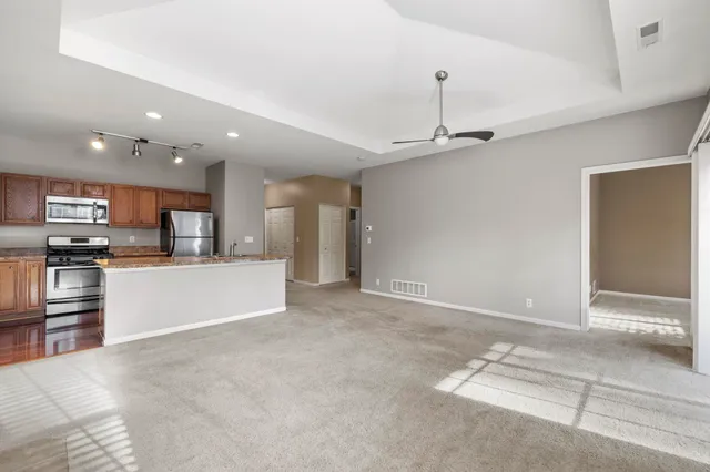 a view of kitchen with stainless steel appliances refrigerator oven and microwave