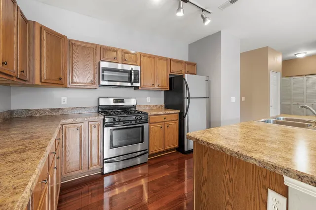 a kitchen with a sink stove and refrigerator