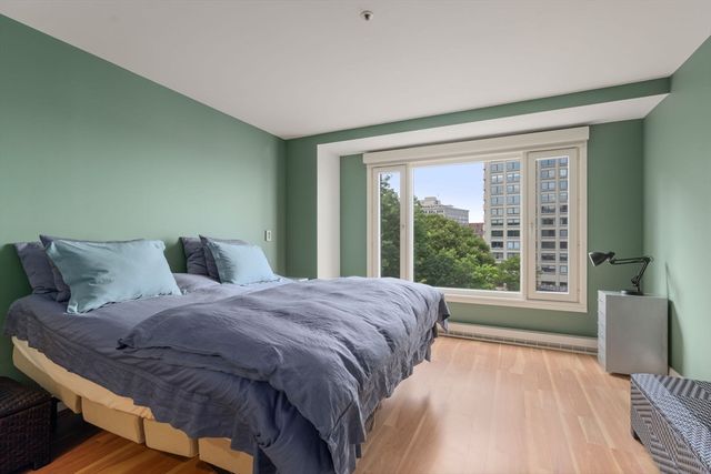 a bedroom with a large bed and a large window