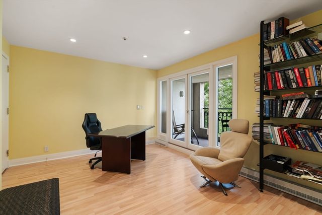 a living room with furniture and a book shelf