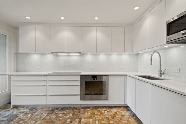 a kitchen with a sink and cabinets