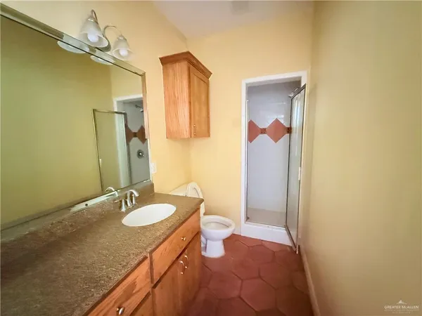 a bathroom with a granite countertop sink and a mirror