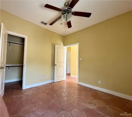 a view of a livingroom with a chandelier & a ceiling fan