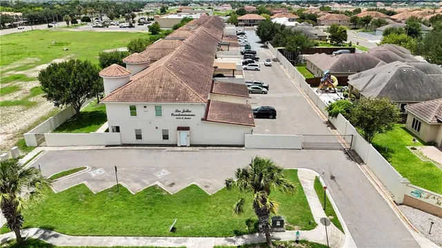 an aerial view of a house with a yard and pool