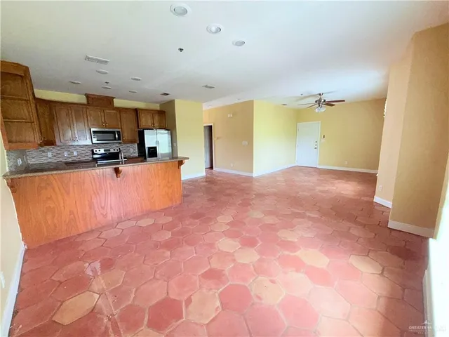a view of kitchen with sink microwave and cabinets