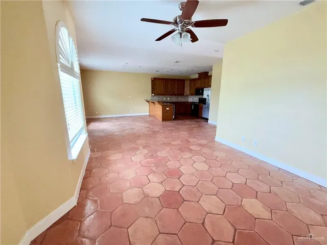a view of a livingroom with a furniture and a ceiling fan