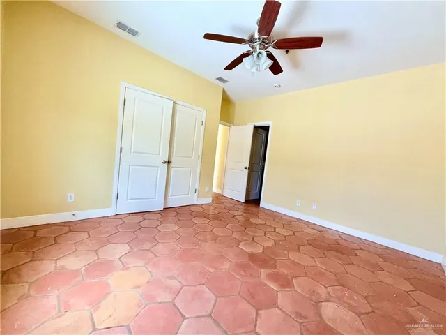 a view of a big room with a ceiling fan