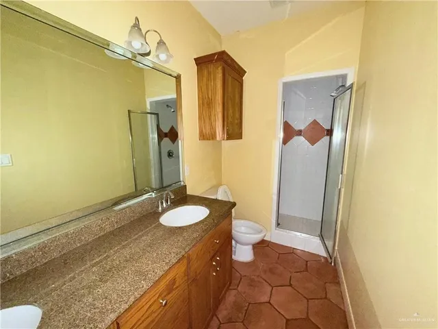 a bathroom with a granite countertop sink and a mirror