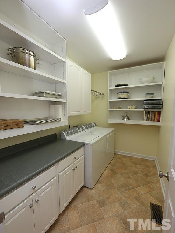 9009 New Century Road Wake Forest, NC 27587 - Photo 11 of 17 First Floor Laundry Room has built in storage.
