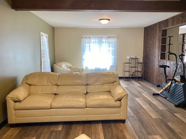 a bedroom with a bed couch and a window