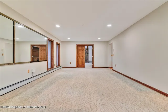 a kitchen with granite countertop a sink and white cabinets
