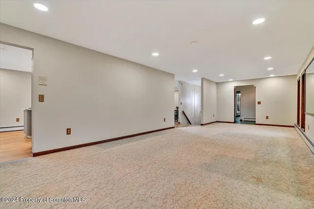 a kitchen with a stove and a wooden floor