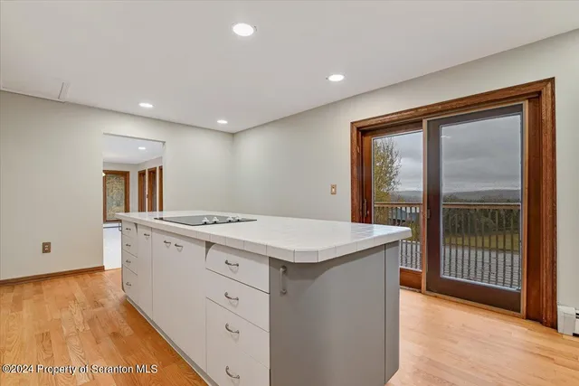 a view of an empty room with a kitchen