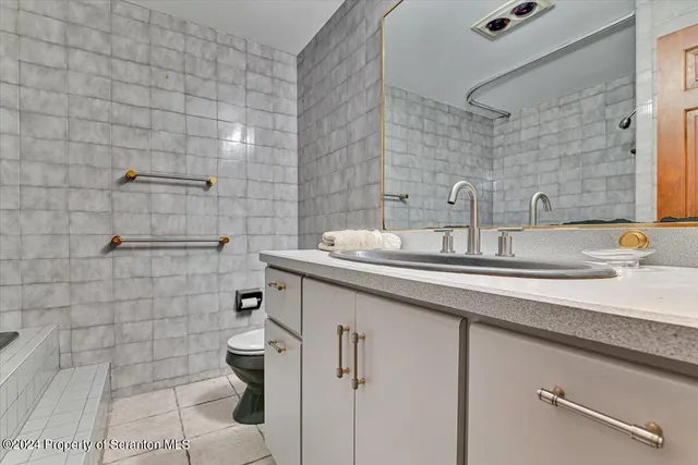 a bathroom with a bathtub and a toilet