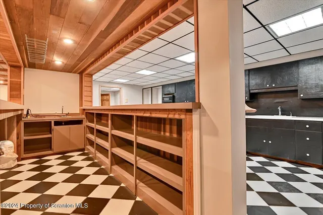 a view of a house with a yard and a large tree