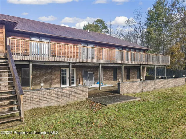 a view of an empty room with cabinet and mirrors