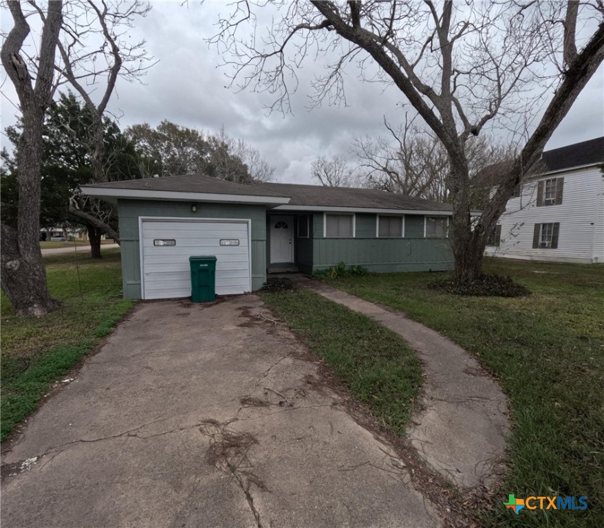 a front view of house with yard and trees