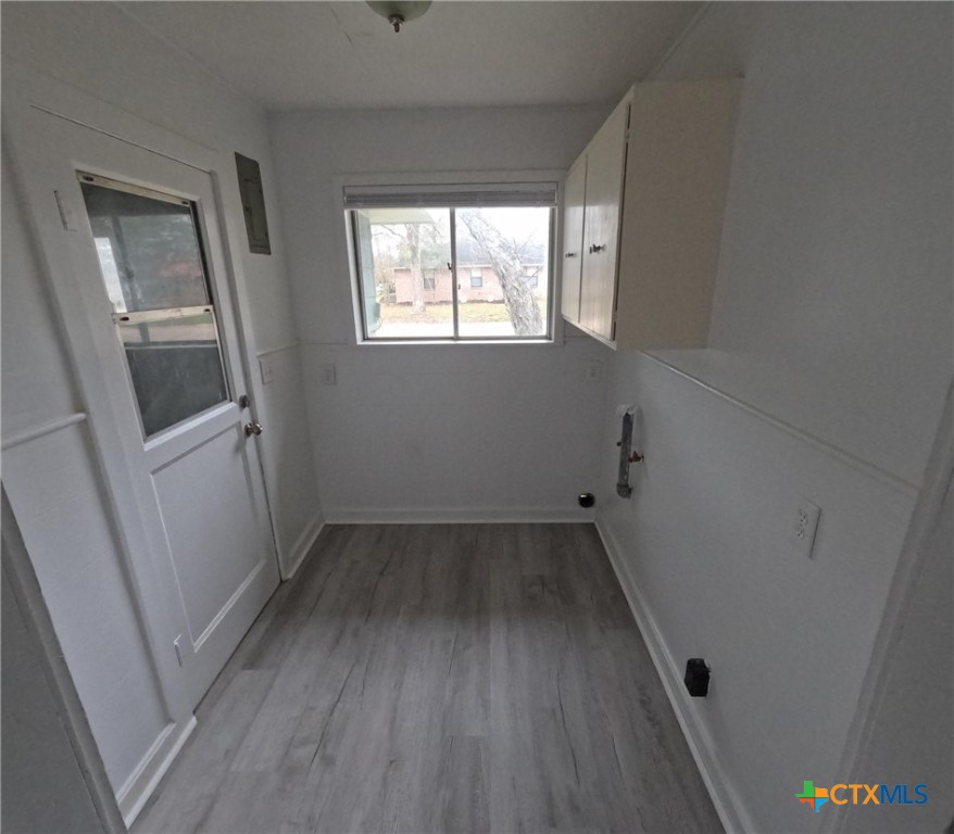 218 North 4th Ganado, TX 77962 - Photo 11 of 19 an empty room with wooden floor and windows
