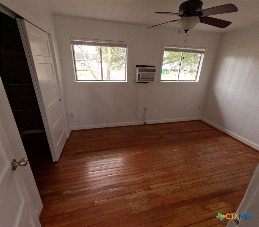 218 North 4th Ganado, TX 77962 - Photo 12 of 19 a view of an empty room with wooden floor and a window