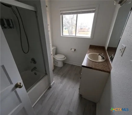 a bathroom with a toilet sink and shower