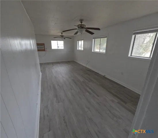 a view of wooden floor and windows in a room