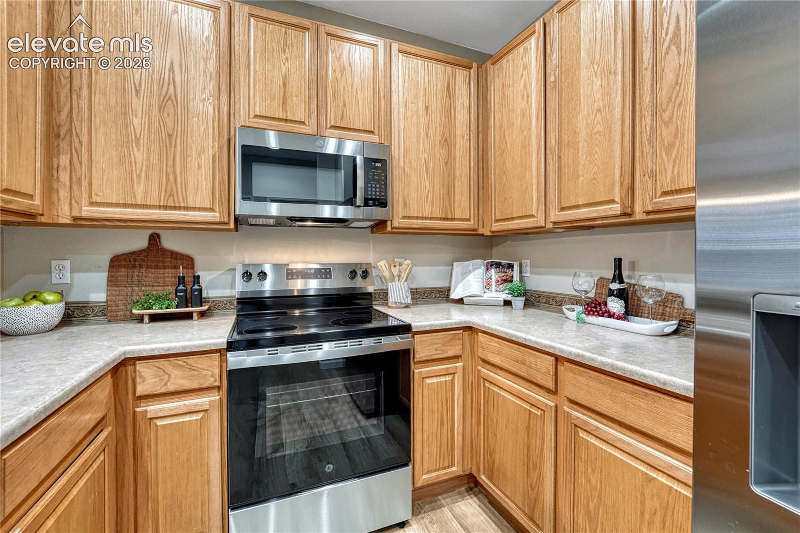 4147 Diamond Ridge View Colorado Springs, CO 80918 - Photo 12 of 42 Sleek, brand-new cooking appliances are beautifully paired with natural wood cabinets, offering plenty of style and space for the home chef