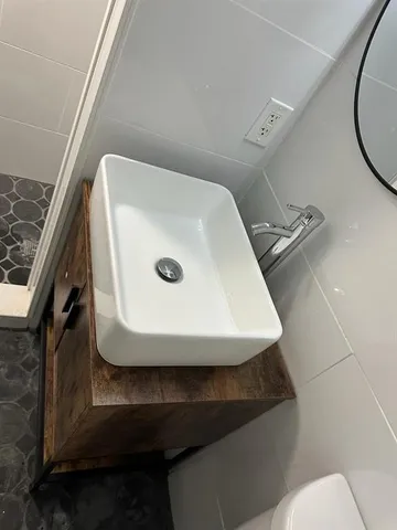 a bathroom with a toilet a sink and a mirror