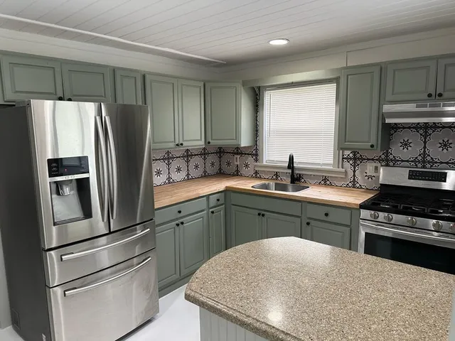 a kitchen with a sink stove and refrigerator