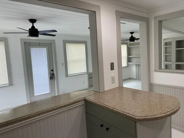 a kitchen with a sink and a mirror