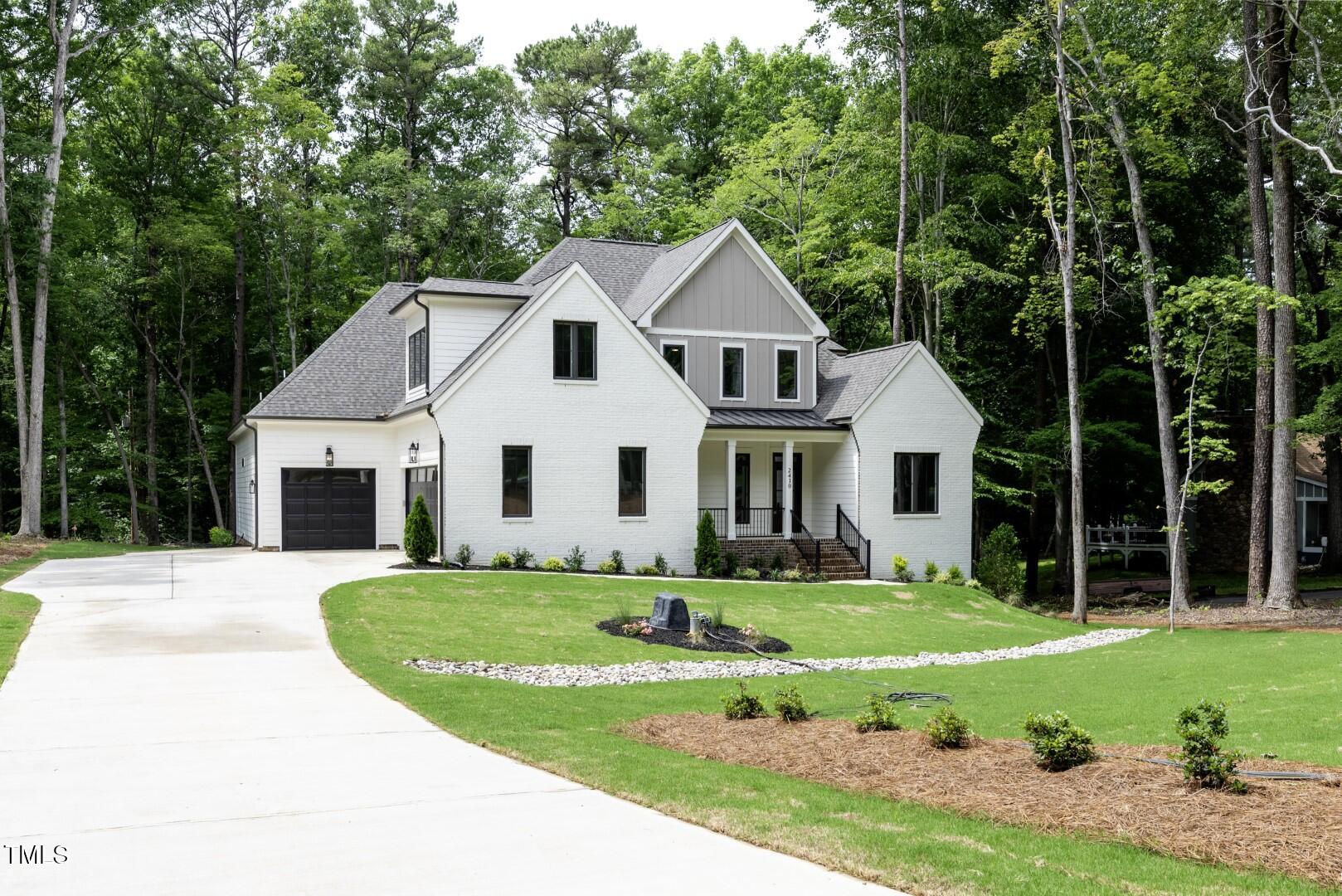 2410 Carpenter Pond Road Raleigh, NC 27613 - Photo 10 of 63 a front view of a house with a yard