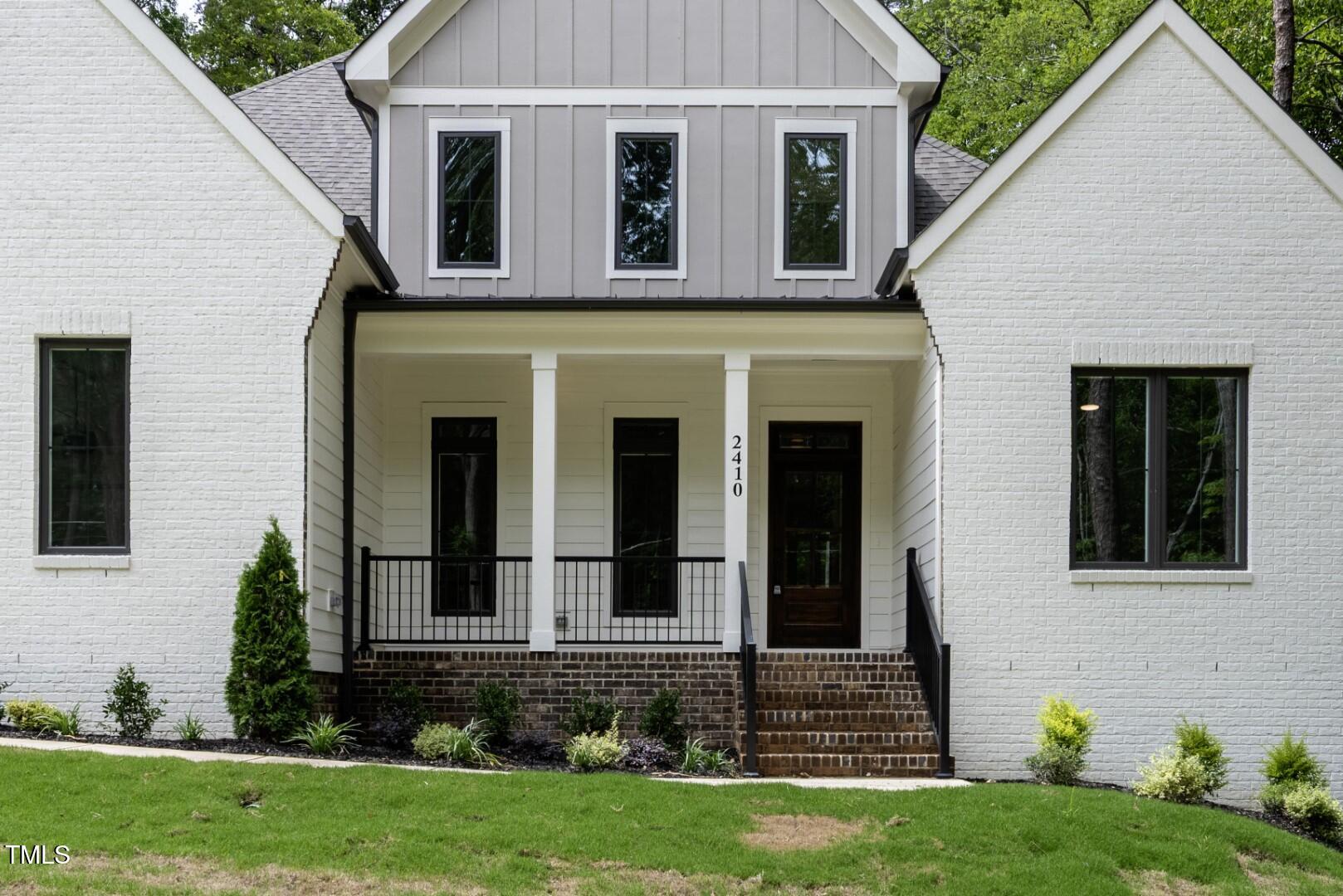 2410 Carpenter Pond Road Raleigh, NC 27613 - Photo 11 of 63 a view of a house with brick walls and a yard with plants