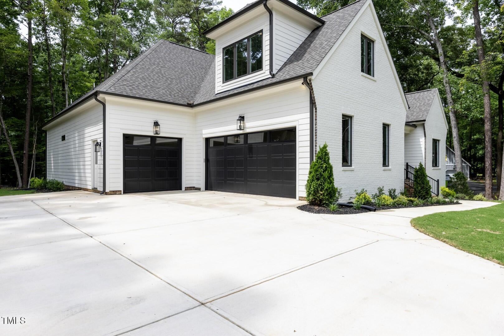 2410 Carpenter Pond Road Raleigh, NC 27613 - Photo 12 of 63 a front view of a house with a yard and garage