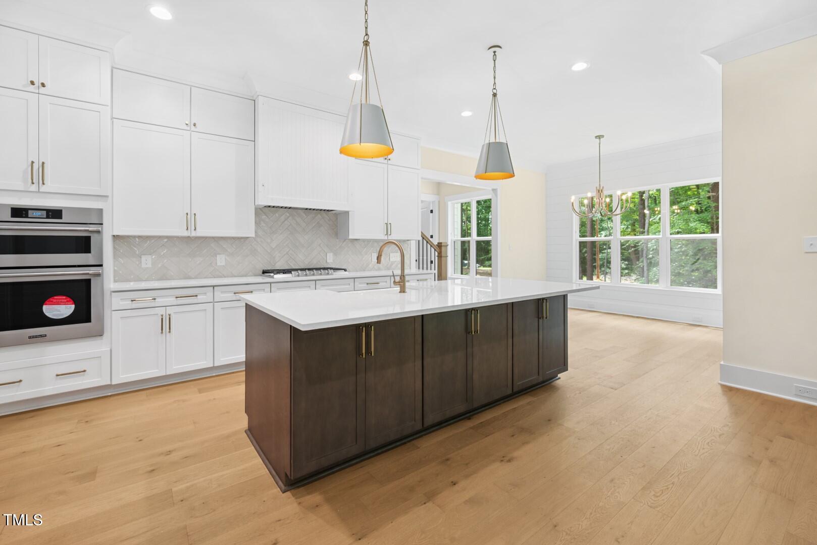 2410 Carpenter Pond Road Raleigh, NC 27613 - Photo 19 of 63 a kitchen with a sink window and cabinets