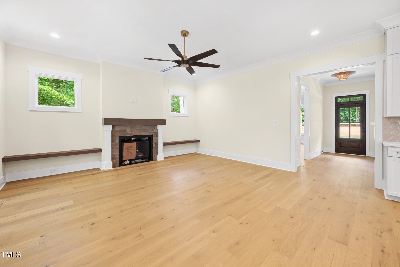 2410 Carpenter Pond Road Raleigh, NC 27613 - Photo 22 of 63 an empty room with windows and fireplace