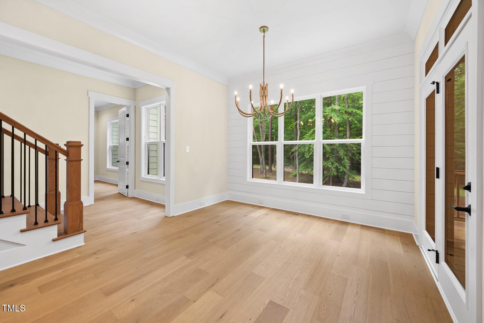 2410 Carpenter Pond Road Raleigh, NC 27613 - Photo 26 of 63 a view of an empty room with wooden floor and a window
